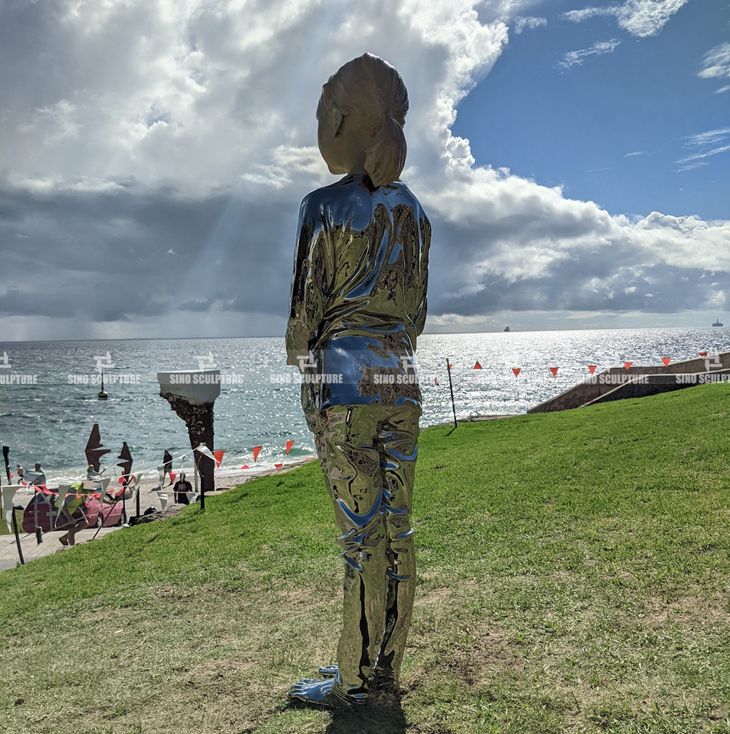 Curved stainless steel statue girl sculpture In Sculpture By the Sea, Cottesloe