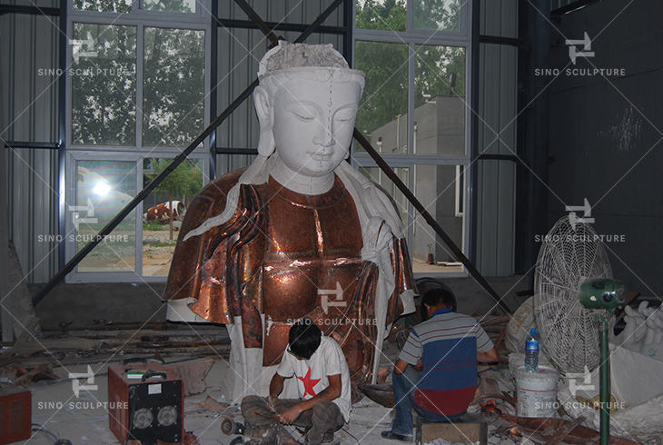 hand-forging the bronze Buddha statue in Sino´s studio in production