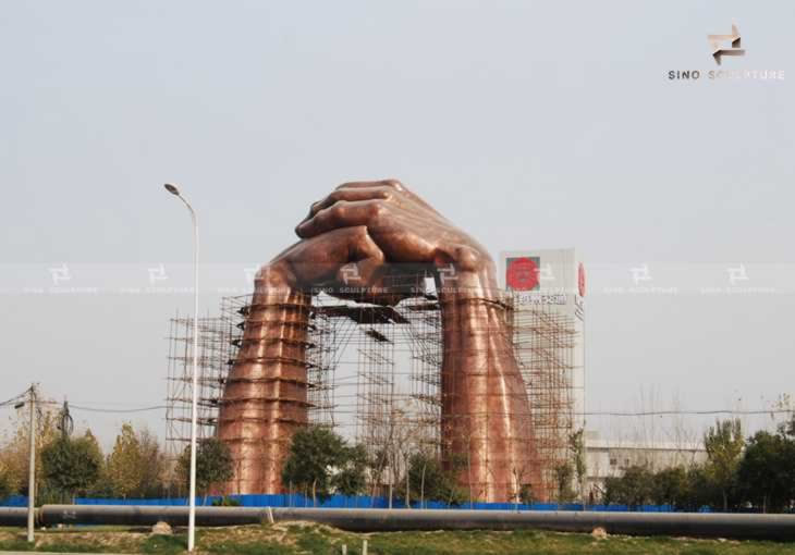 large hand bronze forged sculpture installation