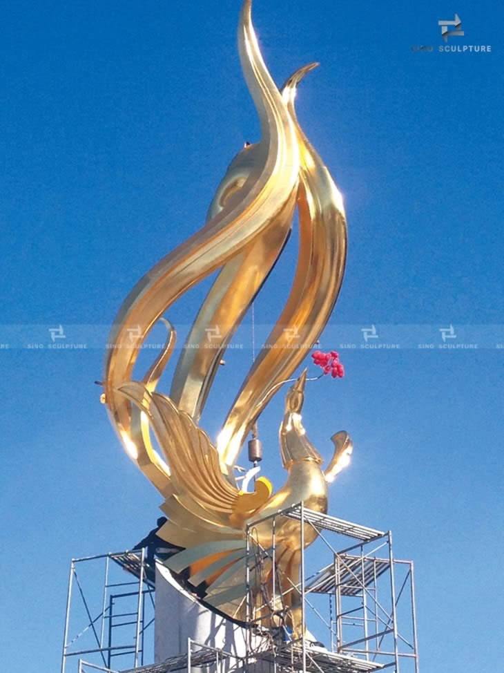 installation photos of the large golden bronze phoenix sculpture