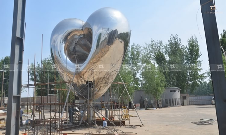 Pre-installation of Love me stainless steel sculpture