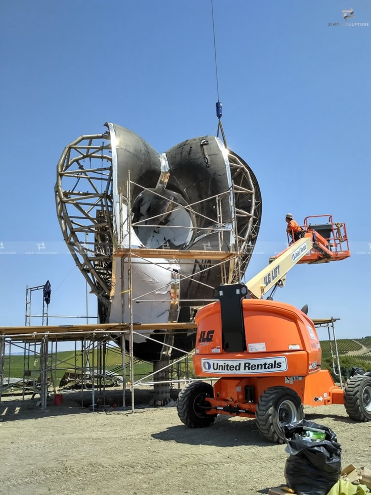 Site installation of Love me stainless steel sculpture in CA, USA