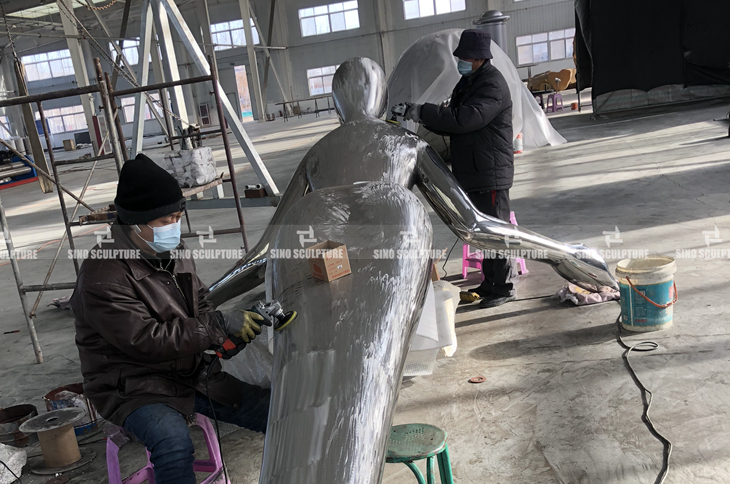 Surface polishing of curved stainless steel statue