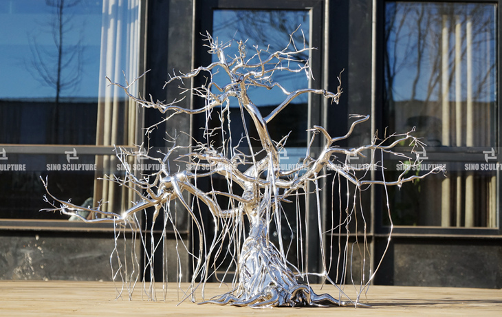 Mirror polished stainless steel cast tree sculpture, artist Mr. Subodh Gupta