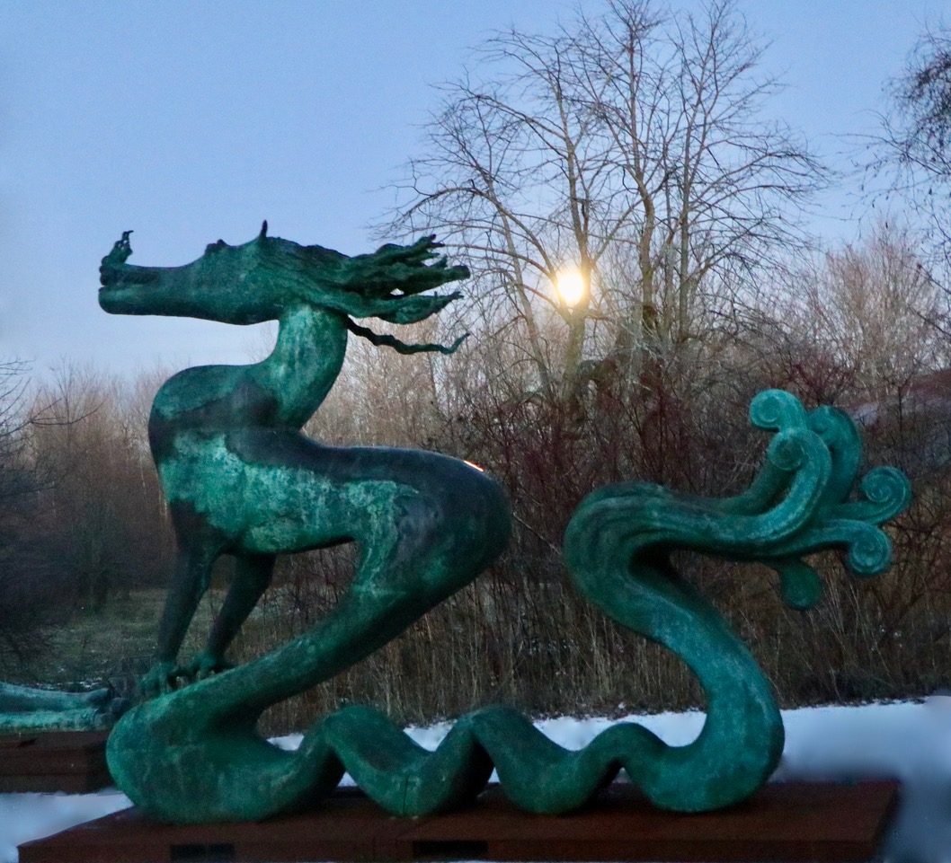 bronze dragon sculpture installed in a sculpture park of Canada