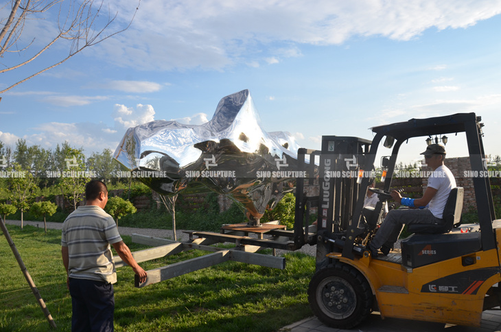 mirror stainless steel rock sculpture installation