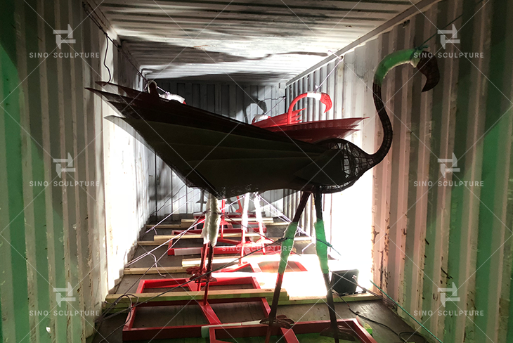 The container loading of the red Flamingo sculpture
