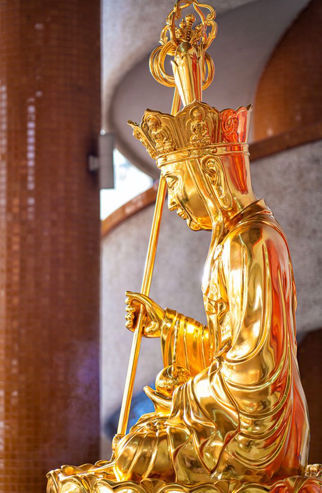 Gold leafed coated seated Ksitigarbha statues at Kong Meng San Phor Kark See Monastery Singapore