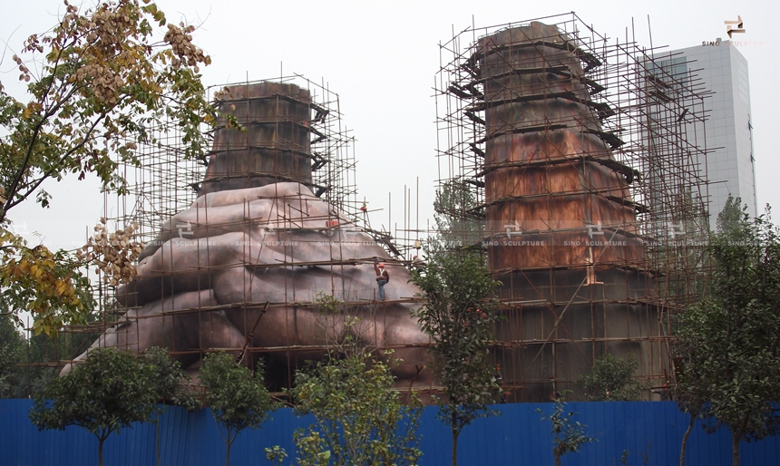 bronze-sculpture-installation.JPG assembling of the large hand sculpture by sino sculpture team at site